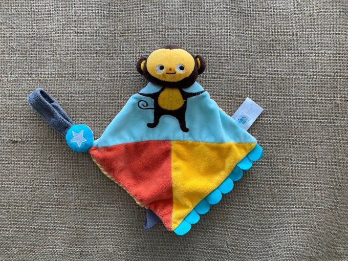 Doudou plat singe cirque bleu orange brun Dreambee d'occasion