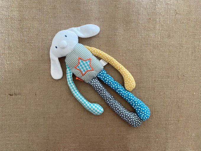 Doudou lapin blanc bleu jaune gris pois rayures étoiles HEMA d'occasion